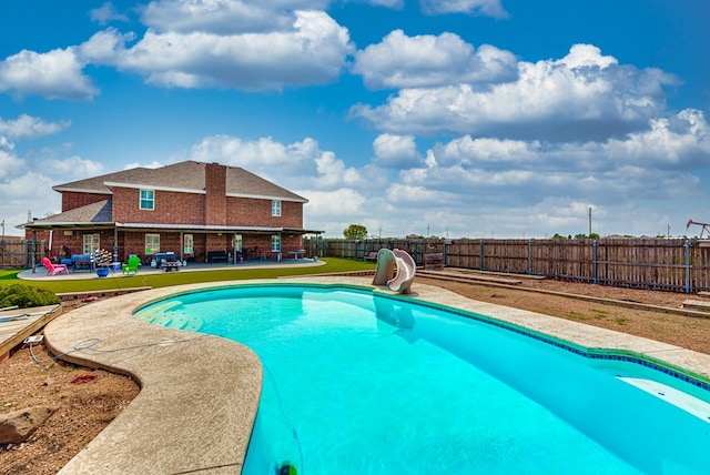 view of swimming pool featuring a patio area and a water slide