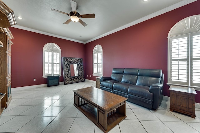 living room with crown molding, ceiling fan, and light tile patterned floors