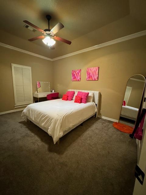 bedroom featuring dark carpet, ceiling fan, and crown molding