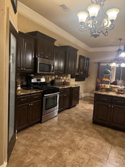 kitchen with a notable chandelier, dark brown cabinets, stainless steel appliances, and decorative light fixtures