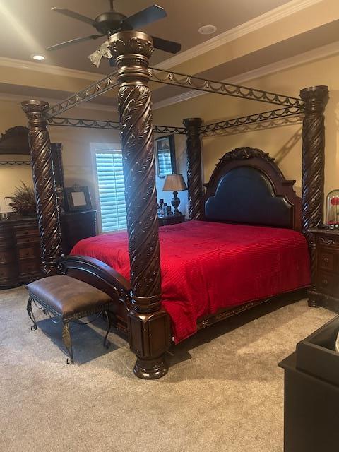 bedroom featuring carpet flooring, crown molding, and a ceiling fan