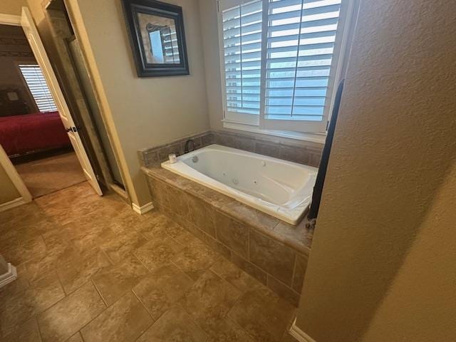 bathroom with a shower stall, a garden tub, a healthy amount of sunlight, and ensuite bathroom