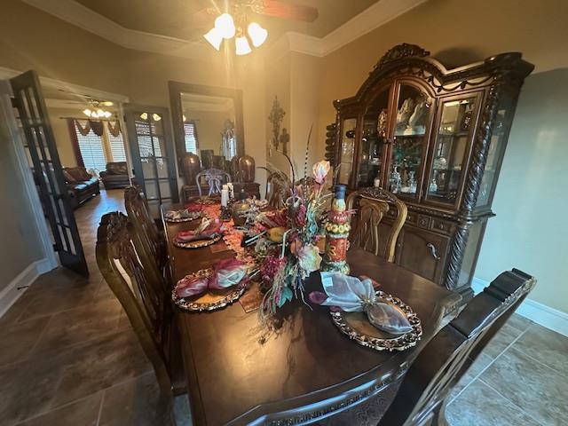 dining space with tile patterned floors, baseboards, and ceiling fan