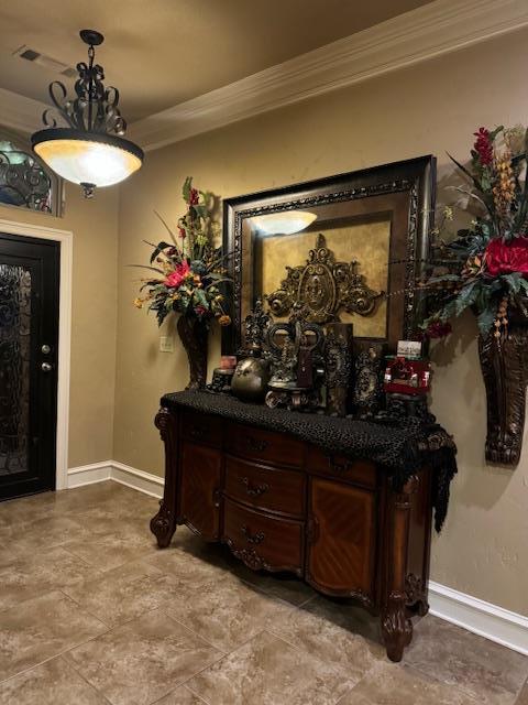 interior space with crown molding and baseboards