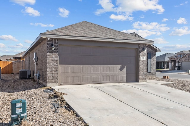 view of side of home featuring a garage and central AC