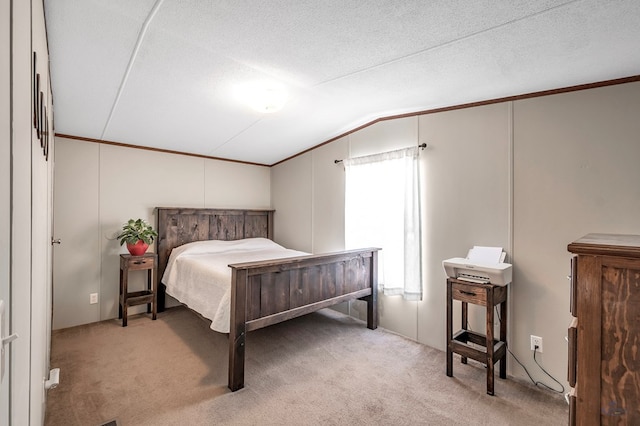 bedroom featuring carpet, a textured ceiling, and vaulted ceiling