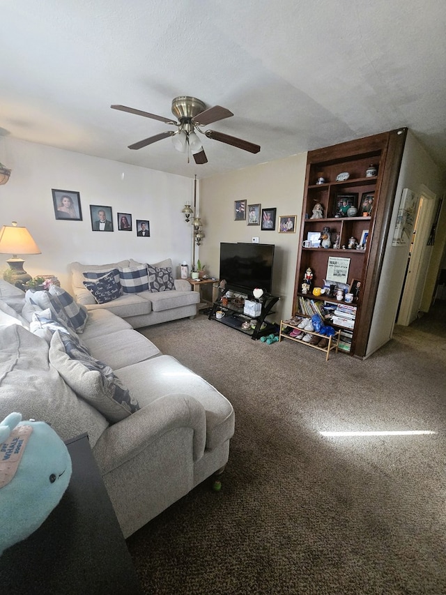 living area with a textured ceiling, carpet flooring, and ceiling fan