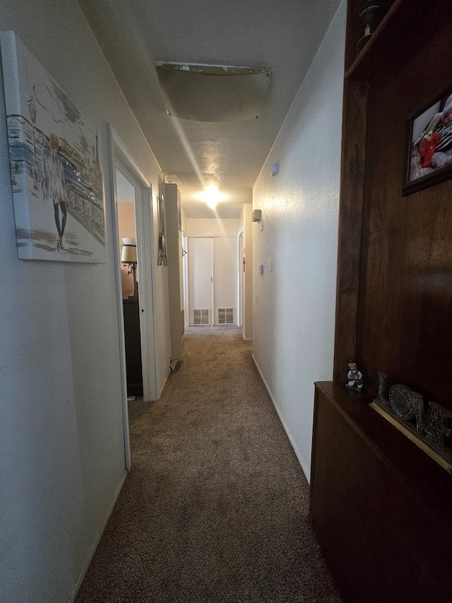 corridor featuring visible vents and carpet floors