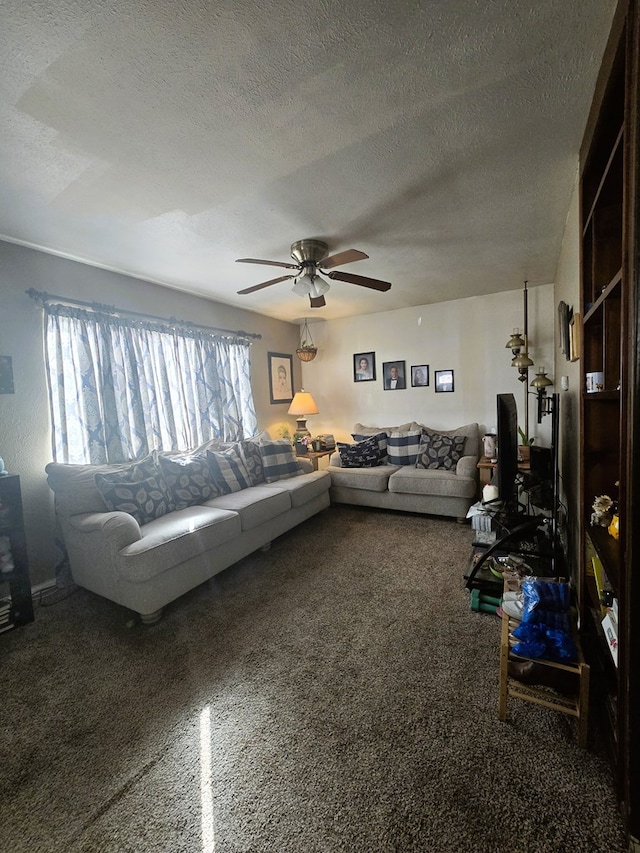 living area with carpet flooring, a ceiling fan, and a textured ceiling