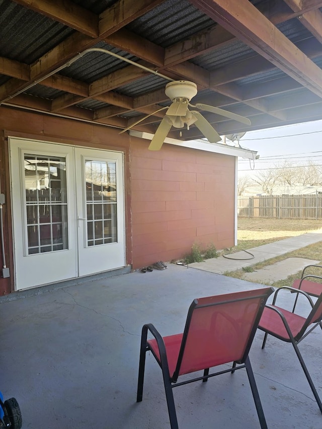 view of patio / terrace featuring french doors, a ceiling fan, and fence