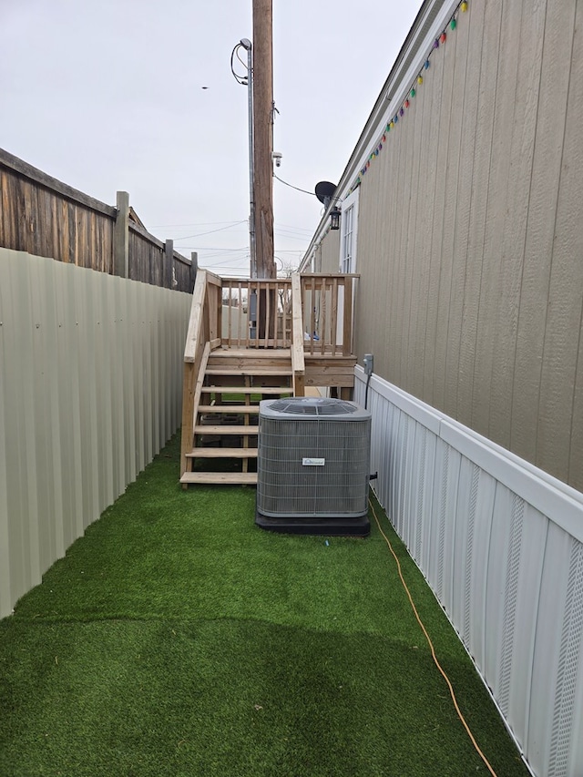 view of yard featuring a wooden deck and cooling unit