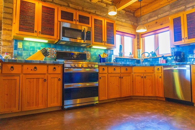 kitchen featuring sink, hanging light fixtures, appliances with stainless steel finishes, and tasteful backsplash