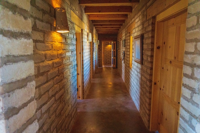 corridor with beam ceiling and brick wall