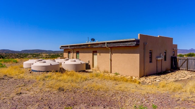 view of property exterior with a mountain view