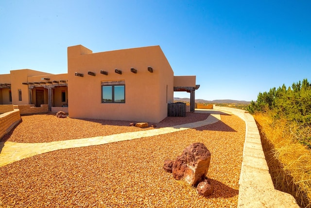 view of home's exterior featuring a pergola