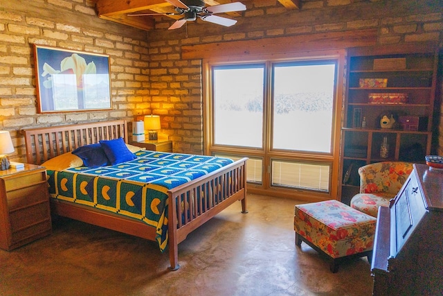 bedroom featuring ceiling fan and brick wall