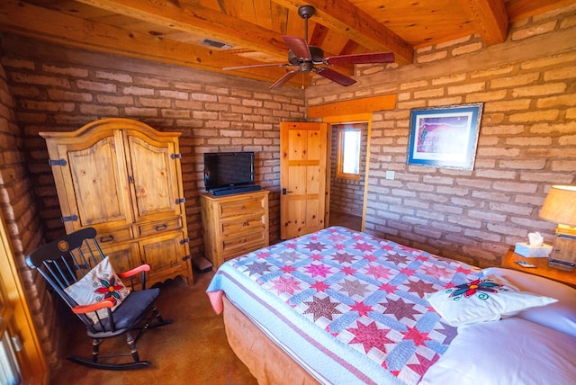 bedroom featuring ceiling fan, beamed ceiling, brick wall, and dark carpet