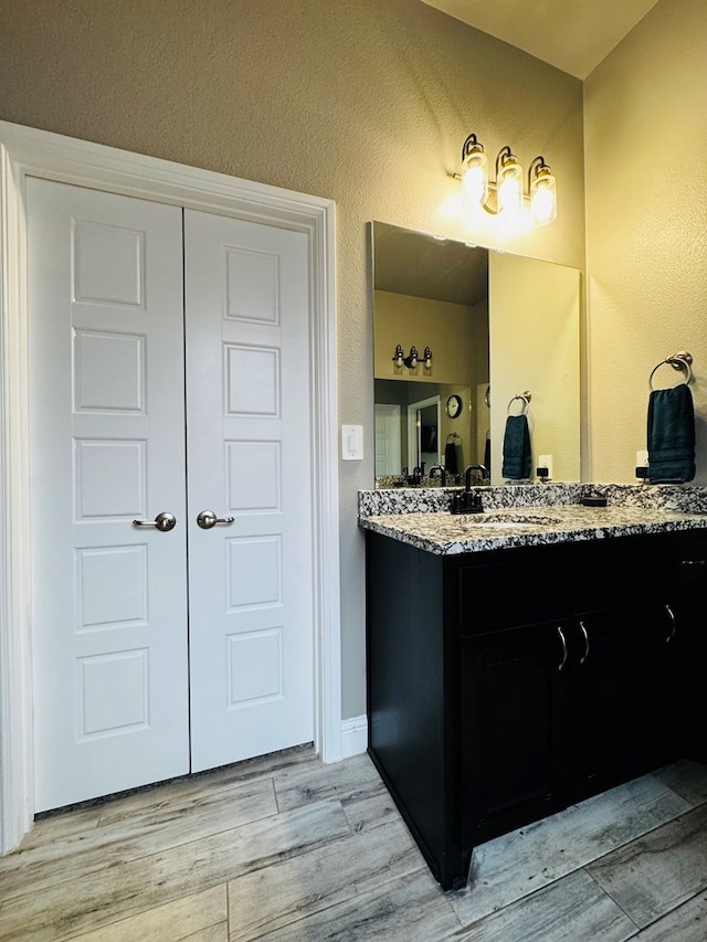 bathroom featuring vanity and wood finished floors