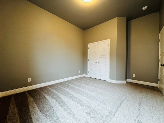 unfurnished bedroom featuring carpet and baseboards