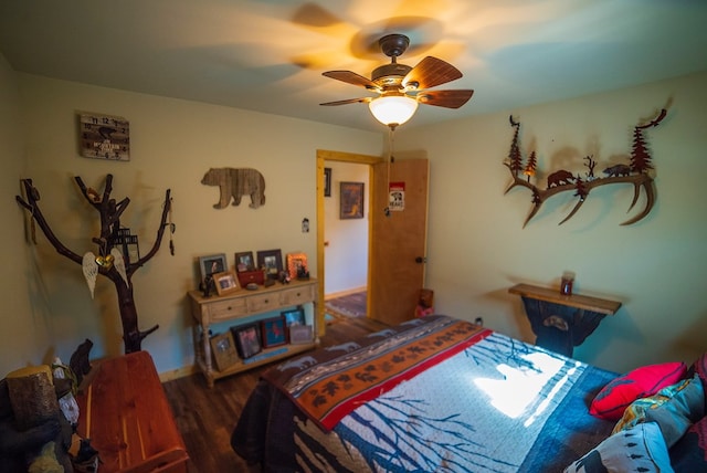 bedroom with dark hardwood / wood-style flooring and ceiling fan