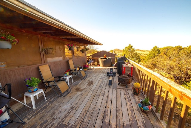 wooden deck with a fire pit