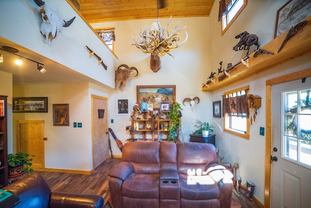 living room with high vaulted ceiling, hardwood / wood-style flooring, an inviting chandelier, and wooden ceiling