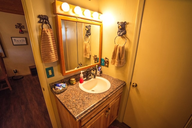 bathroom featuring hardwood / wood-style floors and vanity