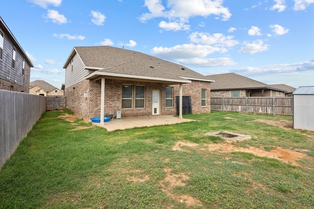 back of house featuring a lawn and a patio