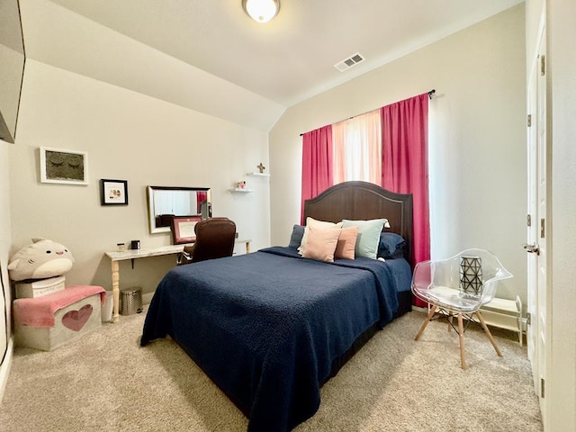 carpeted bedroom with lofted ceiling