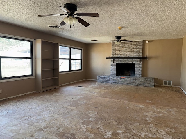 unfurnished living room featuring a textured ceiling, ceiling fan, and a fireplace