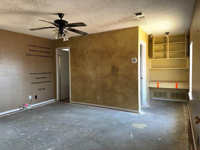 spare room featuring ceiling fan and a textured ceiling