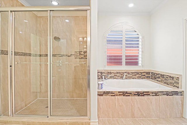 bathroom with crown molding and shower with separate bathtub