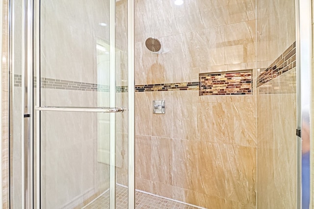 bathroom featuring a shower with door