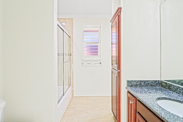 full bathroom with toilet, vanity, tile patterned floors, crown molding, and enclosed tub / shower combo