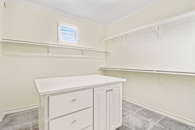 walk in closet featuring light colored carpet