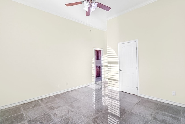 unfurnished room with ceiling fan, a towering ceiling, and crown molding