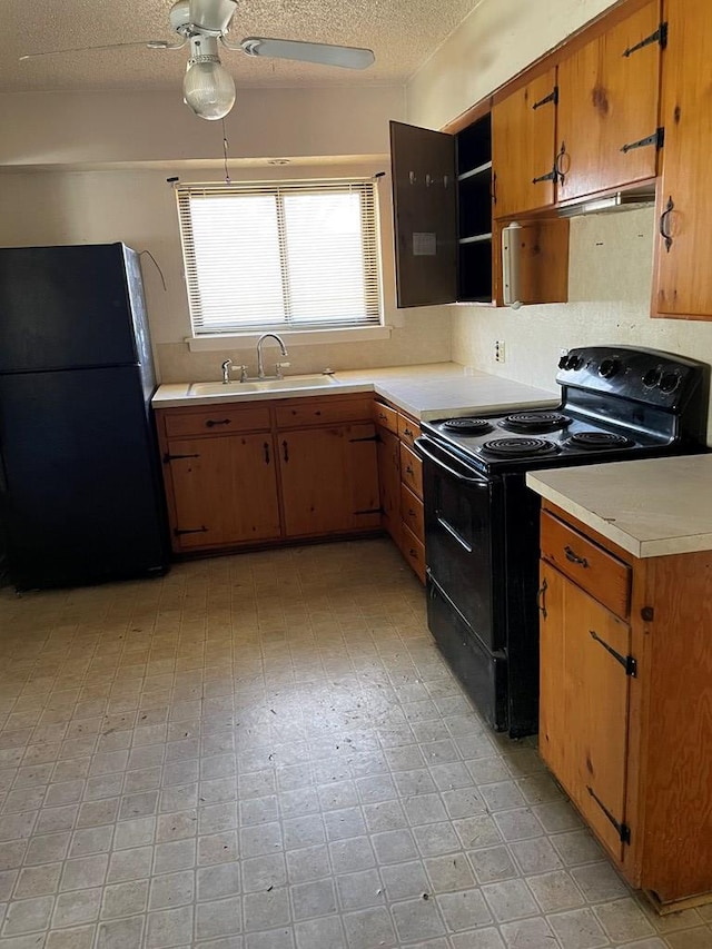 kitchen with sink, a textured ceiling, ceiling fan, and black appliances