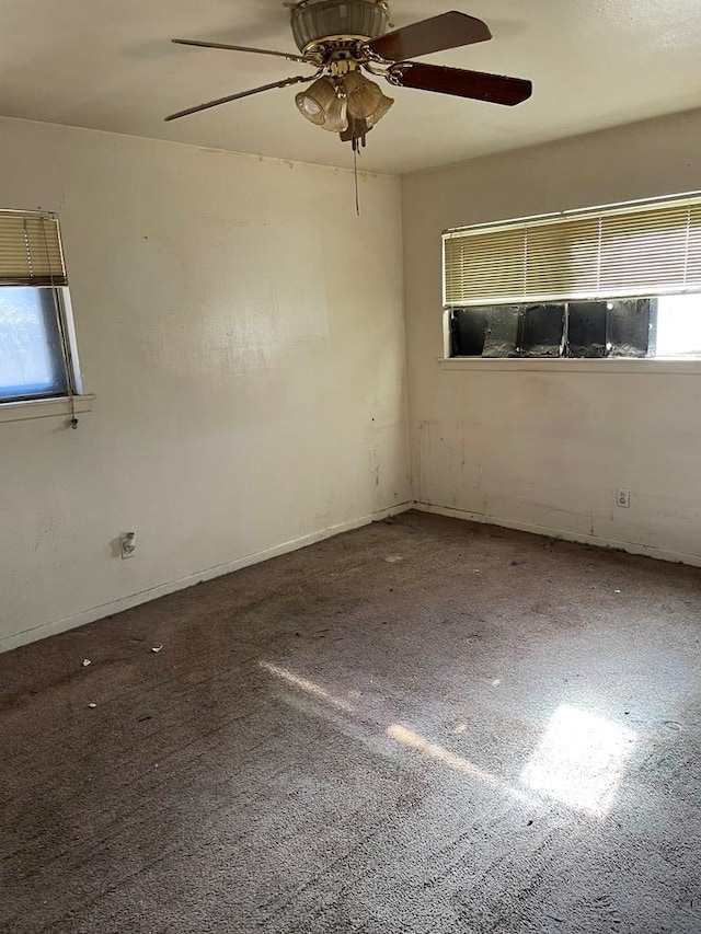 carpeted spare room with ceiling fan