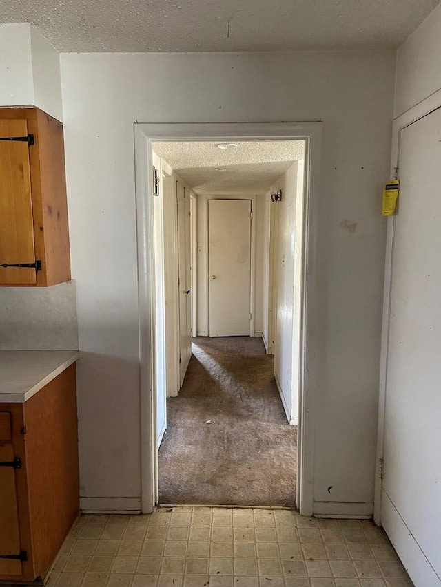 hallway with a textured ceiling