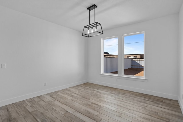 unfurnished dining area featuring light wood-type flooring