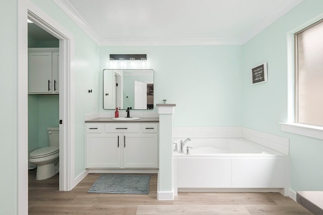 bathroom featuring toilet, a garden tub, wood finished floors, and a healthy amount of sunlight