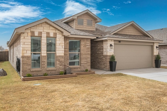 view of front of house featuring a front yard, a garage, driveway, and a shingled roof