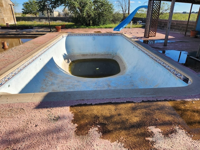 view of swimming pool featuring a jacuzzi and a water slide