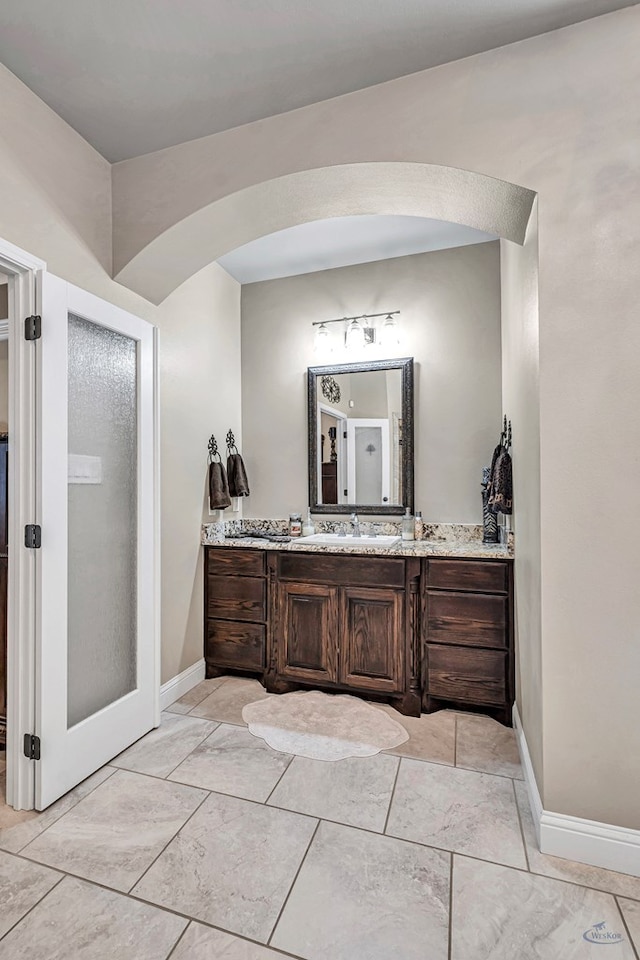 bathroom featuring baseboards and vanity