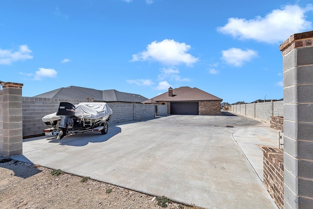 view of patio / terrace with a fenced backyard and a garage