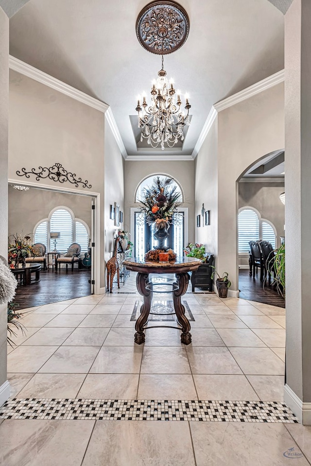 foyer featuring a healthy amount of sunlight, a chandelier, and tile patterned flooring