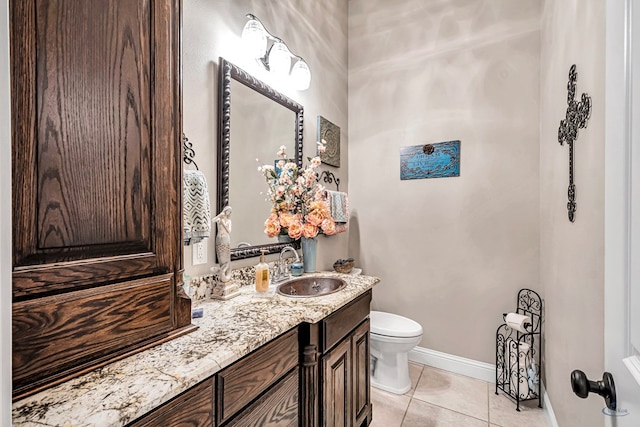 bathroom with tile patterned floors, baseboards, toilet, and vanity