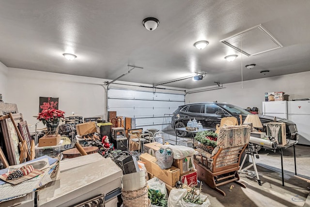 garage with a garage door opener and freestanding refrigerator