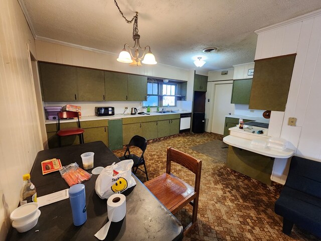 kitchen with dishwasher, sink, green cabinets, a chandelier, and ornamental molding