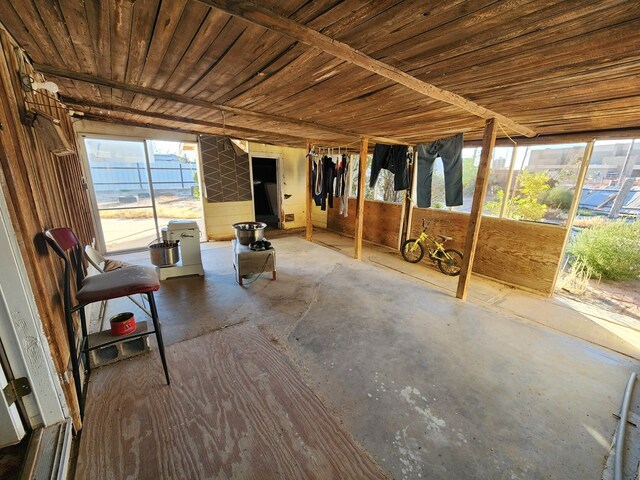 unfurnished sunroom with wood ceiling